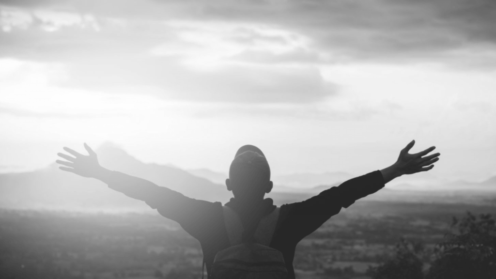 Man worshipping on a mountain.