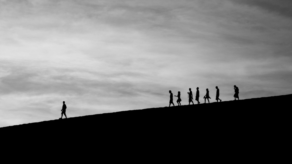 A man leading other men down a mountain.